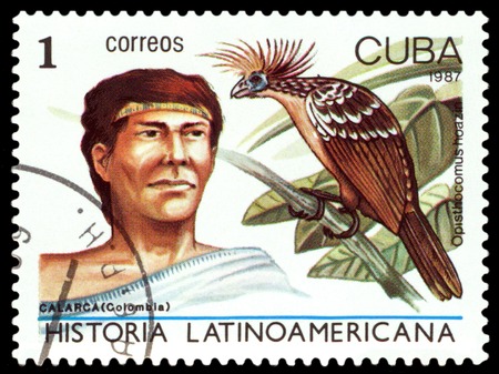 CUBA - CIRCA 1987: A stamp printed by Cuba, shows  Calarca Indian of Colombia and bird Opisthocomus hoazin, Latin American History, series , circa 1987のeditorial素材