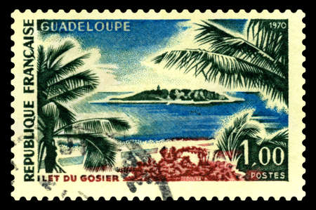 STAVROPOL, RUSSIA - September 08 2020: A stamp printed in France shows view of Ilet du Gosier Guadeloupe, Gozier Island, landscape, circa 1970のeditorial素材