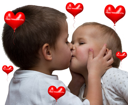 little boy kissing little girl on white backgroundの写真素材