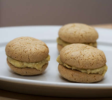 three macaroons on white plate isolated on table  の写真素材