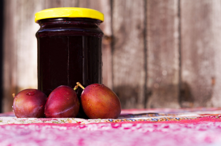 Homemade plum jam with freshly picked plums with wooden backgroundの写真素材