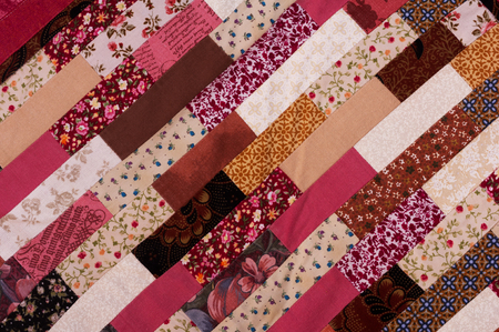 red and brown quilt patchwork texture backgroundの写真素材