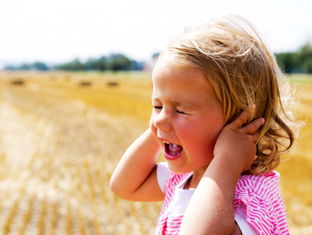 Portrait of a smiling little girl on the meadowの写真素材