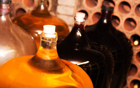 detail of wine bottles with red wine insideの写真素材