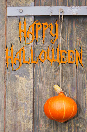 halloween pumpkin on the old wooden background and textの写真素材
