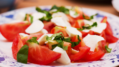 fresh tomato salad with mozzarella and basilの写真素材
