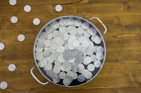 Silver coins in old potの写真素材