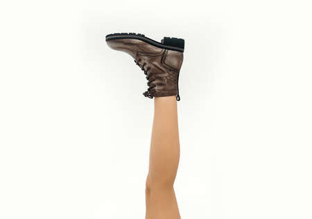 Long woman's leg in the boots on white background. Fashionable bootsの写真素材