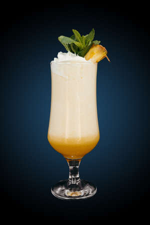 Milkshake with pineapple on blue gradient. Refreshing drinkの写真素材