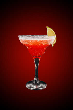 Margarita cocktail with lime isolated on red gradientの写真素材