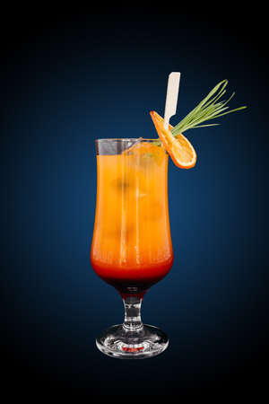 Tequila sunrise Cocktail isolated on a blue gradient. Refreshing drinkの写真素材