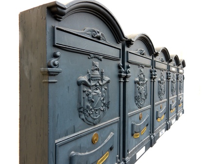 Five ornate metal mailboxes with Coat of Arms in a diminishing row isolated on white.の写真素材