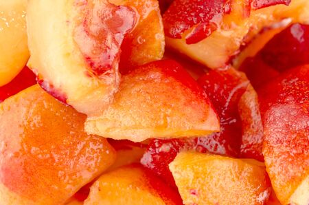 Closeup background of healthy juicy sliced peaches prepared as a delicious dessertの写真素材