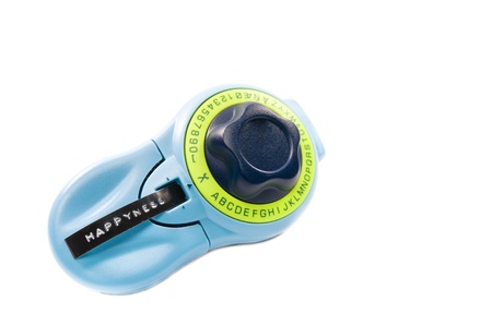 Overhead view of a label writer with Happyness label on plastic adhesive tape isolated on white with...