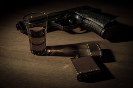 noir desk, with gun schotch and vintage lighterの写真素材