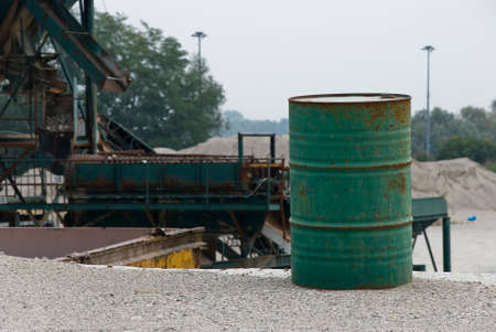 A empty green can-oil in a gravel pitの写真素材