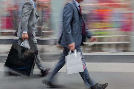 people shopping in the city in motion blur
