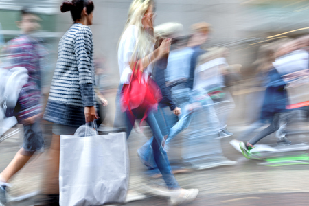 people shopping in the city in motion blur