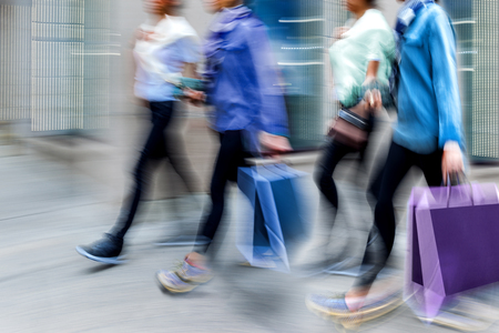 people shopping in the city in motion blur