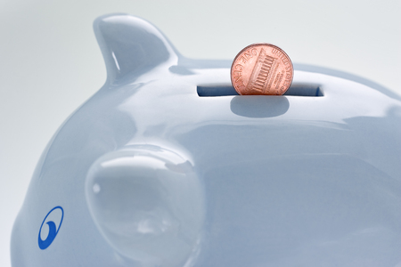 blue piggy bank and a coin falling in it