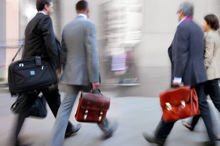 Business people at rush hour walking in the street, in the style of motion blurの写真素材
