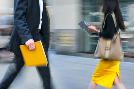 Business people at rush hour walking in the street, in the style of motion blurの写真素材
