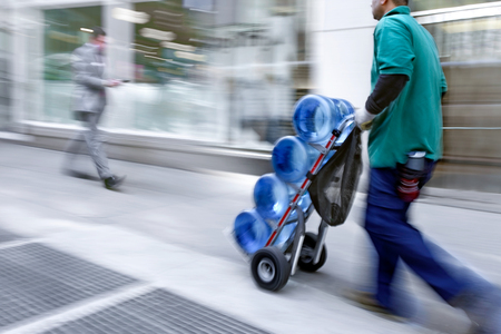 delivery water with dolly by hand, purposely motion blurの写真素材