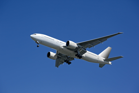 Huge plane taking off in a blue sky closeupの写真素材