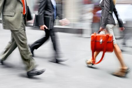 Business people at rush hour walking in the street, in the style of motion blurの写真素材