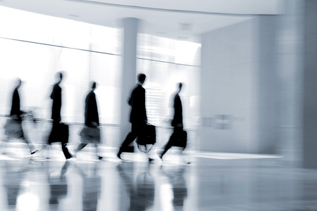 abstakt image of people in the lobby of a modern business center with a blurred background and  blue tonalityの写真素材