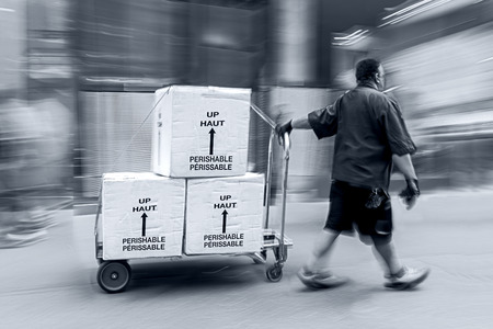 delivery goods with dolly by hand, purposely motion blurの写真素材