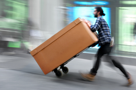delivery goods with dolly by hand, purposely motion blurの写真素材