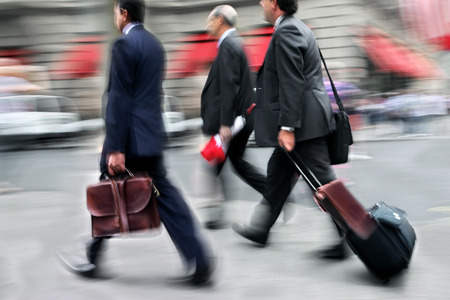 Business people at rush hour walking in the street, in the style of motion blurのeditorial素材