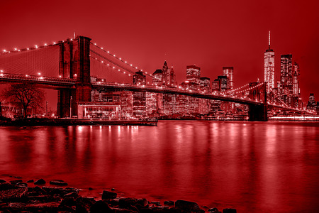 Panoramic view New York City Manhattan downtown skyline at night with skyscrapers and red tonalityのeditorial素材