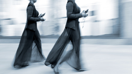 people shopping in the city in motion blur and blue tonalityの写真素材