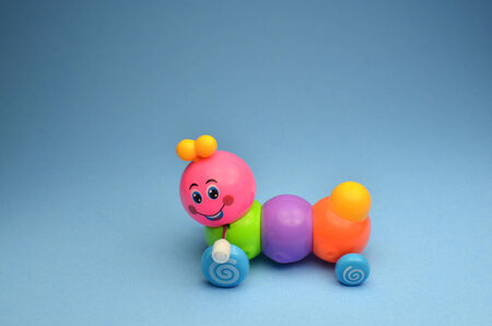 Caterpillar toy on blue backgroundの写真素材