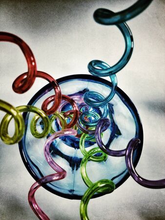 Top view of funny straws and blue swirl glassの素材