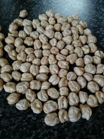 Isolated chickpeas in a dark surfaceの素材