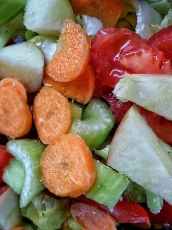 Closeup  view of salad with vegetables and fruit slicesの素材