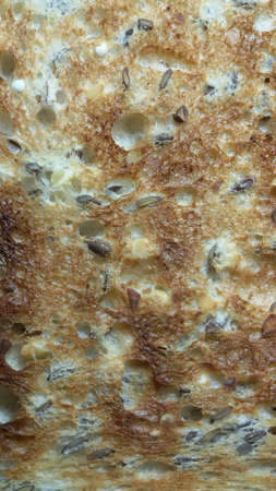 Close up view of toasted bread with seeds and fiber