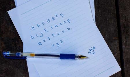 Abc wrote a paper on the wooden floor.の写真素材