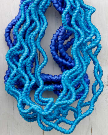 blue braids and purple fabric on woodの写真素材