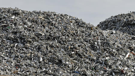 Scrap metal and chipboard shine in the sunの写真素材