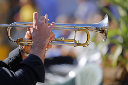 the jazz musician plays his shining trumpet