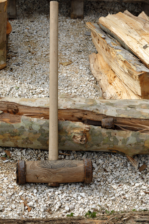big woodcutter hammer leaning on a trunkの写真素材