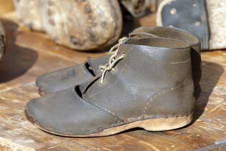 two old leather shoes with string cordの写真素材
