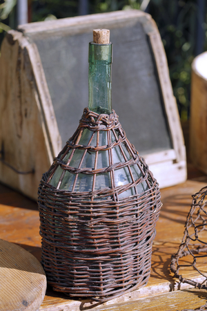 old bottle with wicker sprigsの写真素材