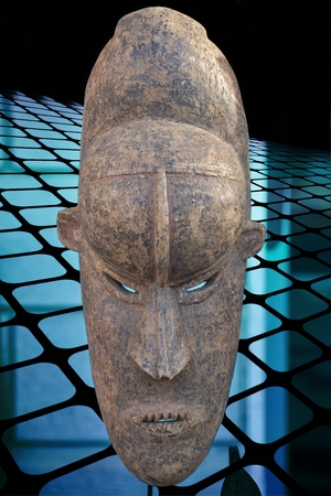 African mask on blue checked abstract backgroundの写真素材