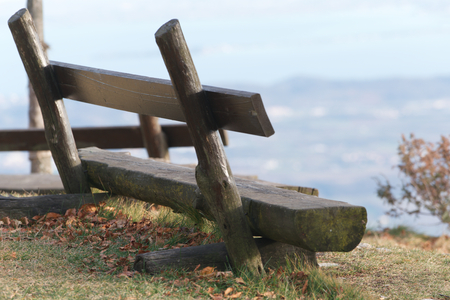 benches carved from wooden logs in a mountain path