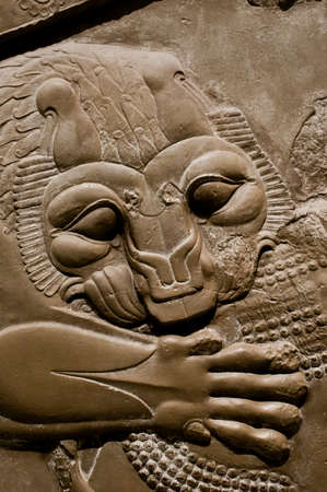 LONDON - JANUARY 9 2014 - An exhibit in the British Museum, London, shows a relief from circa 440BC of a lion attacking an ox in a 19th century cast of carvings from the Palace of Darius, Persepolis, Iranのeditorial素材